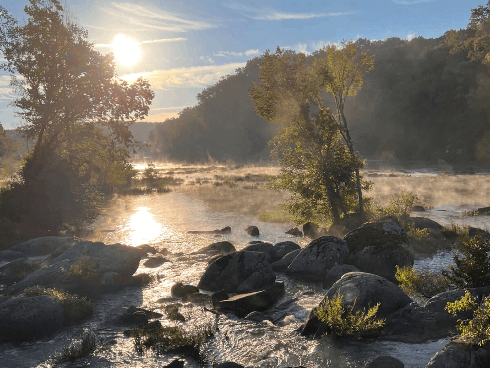 Sunrise mist over rocks in the Deep River at the former High Falls Dam site, North Carolina