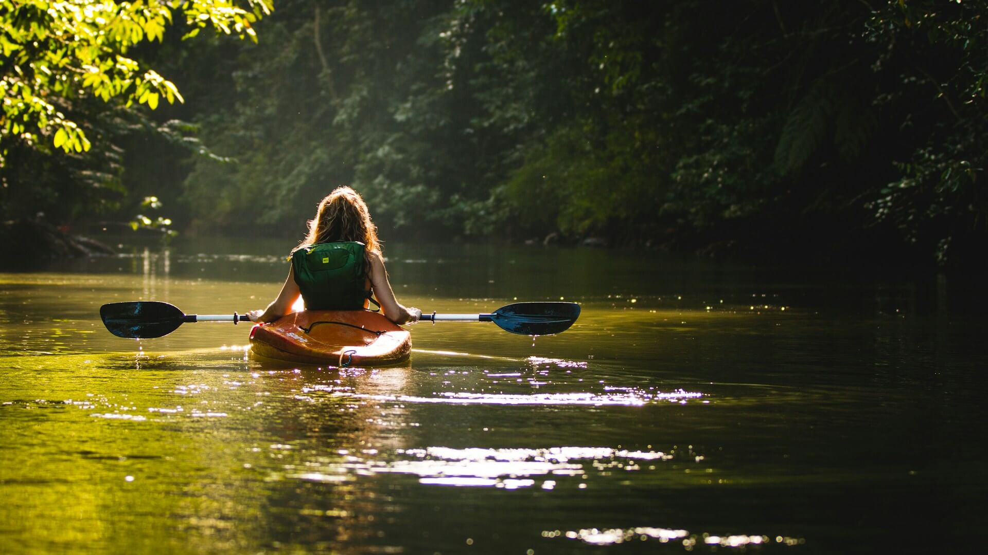 photo of person kayaking on a wild scenic river